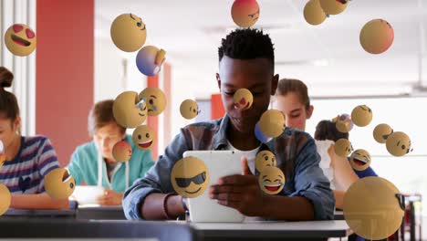Animation-of-emoticons-over-diverse-students-in-class-using-tablets