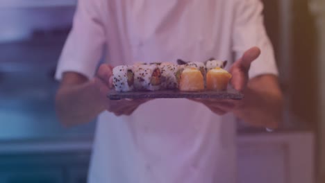 Animation-of-biracial-male-chef-holding-sushi