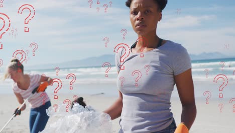 Animation-of-question-marks-over-biracial-female-volunteer-picking-up-rubbish-on-beach