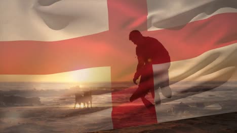 Animation-of-flag-of-england-over-caucasian-man-with-dogs-at-beach