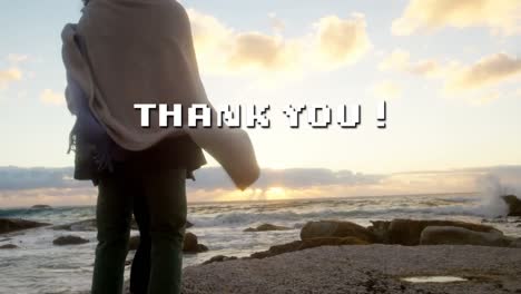 Animation-of-thank-you-text-over-african-american-couple-at-beach
