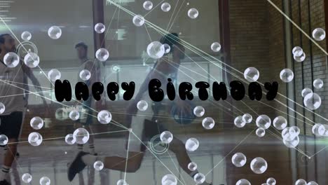 Animation-of-happy-birthday-text-and-bubbles-over-diverse-group-of-basketball-players-at-gym