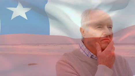 Animation-of-flag-of-chile-over-thoughtful-senior-caucasian-man-on-beach