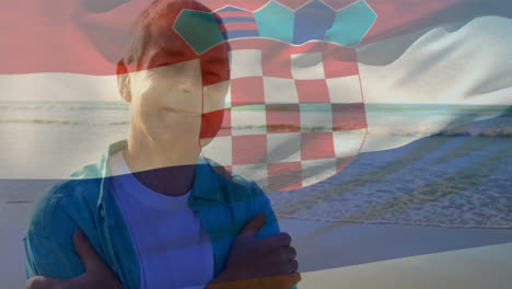 Animation-of-flag-of-croatia-over-happy-senior-caucasian-man-on-beach
