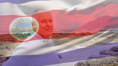 Animación-De-La-Bandera-De-Costa-Rica-Sobre-Un-Hombre-Caucásico-Mayor-En-La-Playa