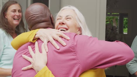Animation-of-happy-caucasian-senior-woman-embracing-african-american-male-friend