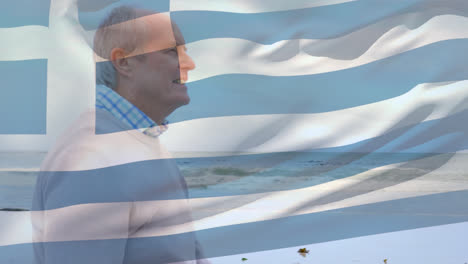Animation-of-flag-of-greece-over-happy-senior-caucasian-man-on-beach