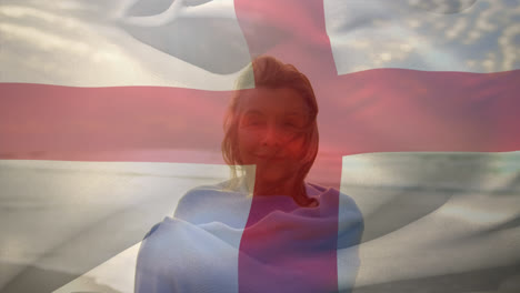 Animation-of-flag-of-england-over-happy-senior-caucasian-woman-on-beach