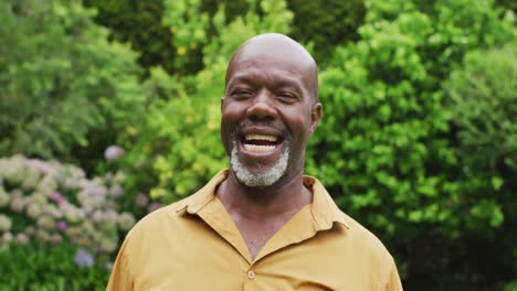 Animation-of-african-american-senior-man-smiling-at-camera-in-garden