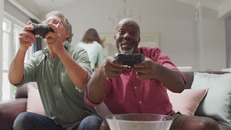 Animation-of-happy-diverse-male-senior-friends-playing-video-games