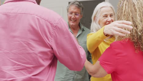 Animation-of-happy-caucasian-senior-couple-welcoming-friends