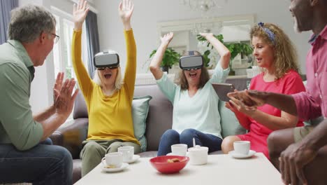 Animation-of-happy-diverse-female-and-male-senior-friends-using-vr-headset-and-having-fun