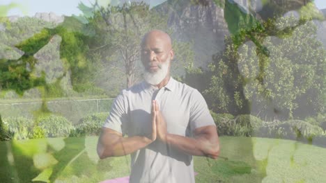 Animation-of-leaves-over-senior-african-american-man-practicing-yoga-and-meditating