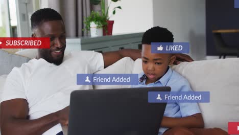 Animation-of-subscribe-over-happy-african-american-father-and-son-using-laptop