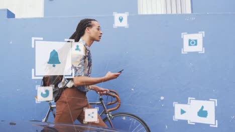 Animation-of-media-icons-over-biracial-man-walking-with-bicycle