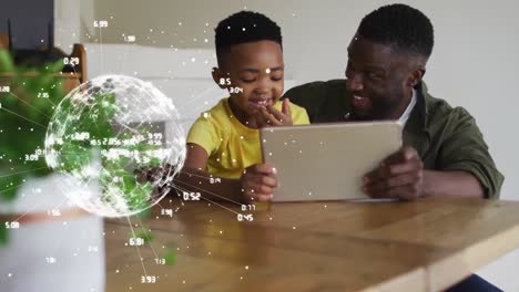 Animation-of-globe-with-numbers-over-happy-african-american-father-and-son-using-tablet