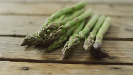 Video-of-fresh-asparagus-stalks-on-wooden-background
