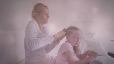 Animation-of-glowing-spots-over-happy-caucasian-mother-making-ponytail-for-her-daughter