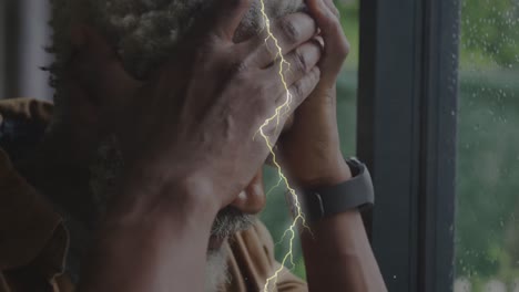 Animation-of-lightning-over-sad-senior-african-american-man