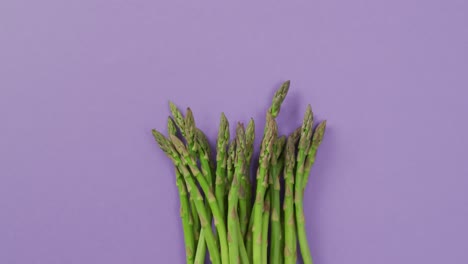Video-of-fresh-asparagus-with-copy-space-over-lilac-background
