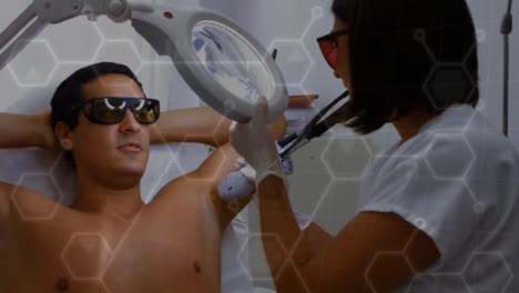Animation-of-chemical-formulas-over-diverse-male-patient-and-female-doctor-during-laser-treatment
