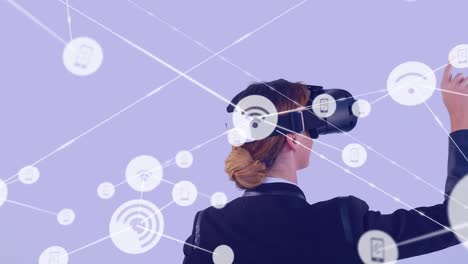 Animation-of-network-of-connections-with-icons-over-caucasian-businesswoman-using-vr-headset