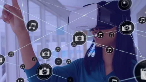 Animation-of-network-of-connections-with-icons-over-biracial-businesswoman-using-vr-headset