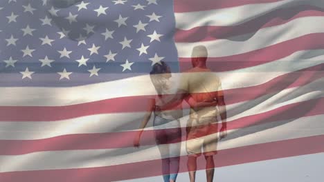 Animation-of-american-flag-over-diverse-couple-at-beach