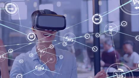 Animation-of-network-of-connections-with-icons-over-happy-caucasian-businesswoman-using-vr-headset