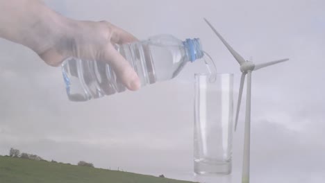 Animation-of-caucasian-woman-pouring-water-into-plastic-bottle-and-wind-turbine