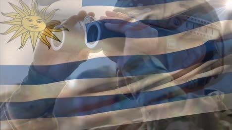 Animation-of-flag-of-uruguay-over-biracial-male-soldier-with-binoculars