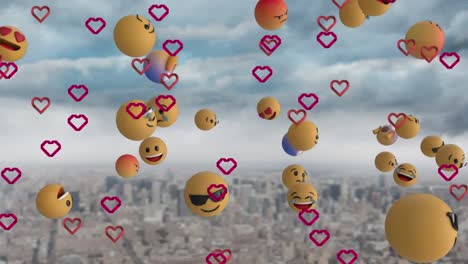Animation-of-heart-and-emoji-icons-over-cityscape