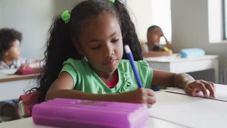 Video-of-focused-african-american-girl-doing-lessons-in-classroom