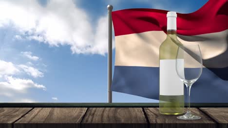 Animation-Einer-Flasche-Weißwein,-Eines-Glases-Und-Einer-Flagge-Frankreichs,-Die-über-Einem-Hintergrund-Mit-Wolken-Weht
