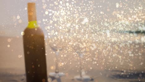 Animation-of-gold-dots-over-blurred-bottle-of-red-wine-on-beach