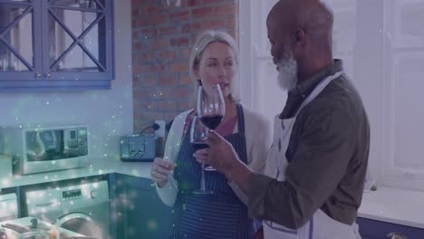 Animation-of-lights-over-diverse-senior-couple-drinking-wine-at-home