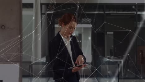 Animation-of-network-of-connections-over-caucasian-businesswoman-using-tablet