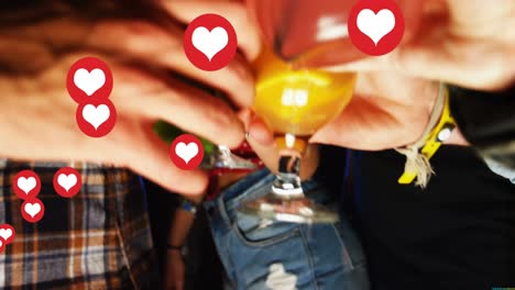 Animation-of-hearts-over-diverse-friends-with-drinks