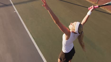 Video-of-top-view-of-caucasian-female-tennis-player-holding-racket-and-hitting-ball
