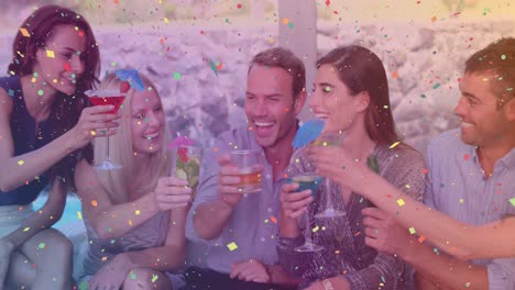 Animation-of-confetti-over-happy-diverse-friends-with-drinks