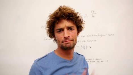 Confused-student-standing-in-front-of-whiteboard-of-math
