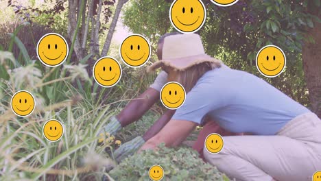 Animation-of-emoji-icons-over-diverse-senior-couple-gardening
