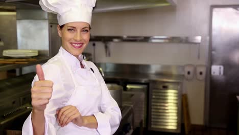 Pretty-chef-smiling-at-camera-and-giving-thumbs-up