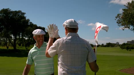 Golfers-high-fiving-on-the-eighteenth-hole