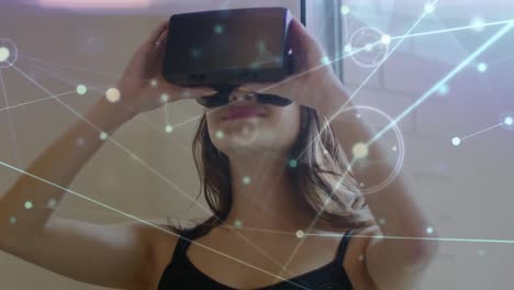 Animation-of-network-of-connections-over-caucasian-woman-using-vr-headset