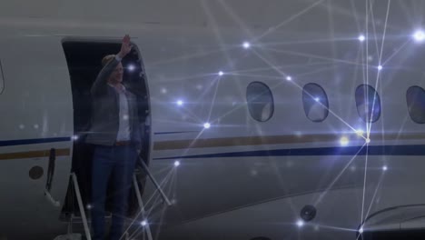 Animation-of-network-of-connections-over-businessmen-at-the-airport