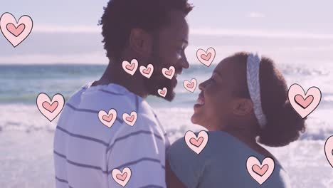 Animation-of-heart-icons-over-african-american-couple-on-beach