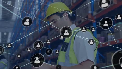 Animation-of-network-of-connections-with-icons-over-caucasian-male-worker-in-warehouse