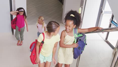 Video-of-happy-diverse-girls-walking-upstairs-at-school-and-talking