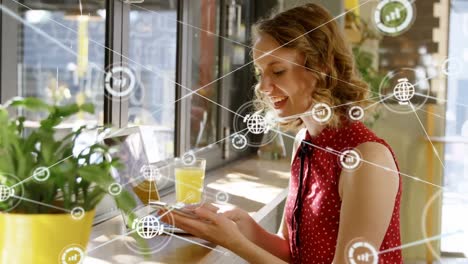 Animation-of-network-of-connections-with-icons-over-happy-caucasian-woman-using-smartphone